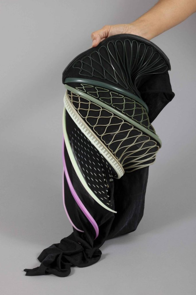 Black stretch fabric shaped into a curved form by a printed lattice